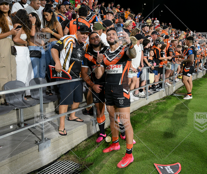 Wests Tigers players Royce Hunt and Starford T'oa taking selfies with fans after win over Raiders at Leichhardt Oval